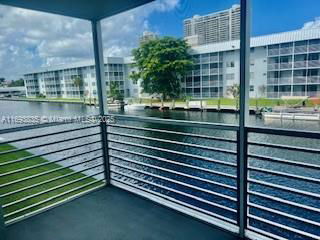 View from a balcony showing water and apartment buildings across a canal.