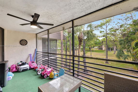 Indoor balcony area with children's toys and a dartboard on the wall.