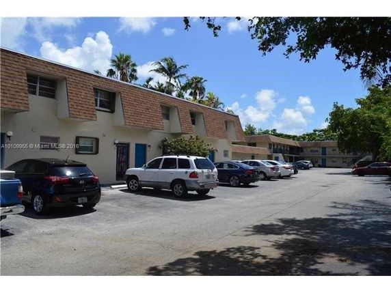 Outdoor parking area in front of residential buildings.