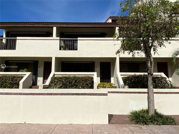 Front view of a two-story residential building with balconies.