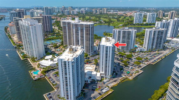 Aerial view of multiple high-rise apartment buildings near a waterway.