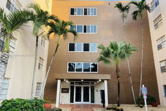 Front view of a multi-story apartment building with modern architecture.