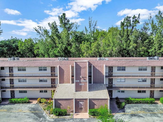 Front view of a multi-story apartment building with balconies.