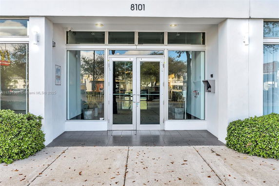 Front view of a building with a glass entrance and house number 8101.