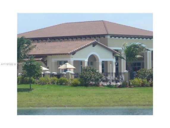 Front view of a large building with a red-tiled roof.
