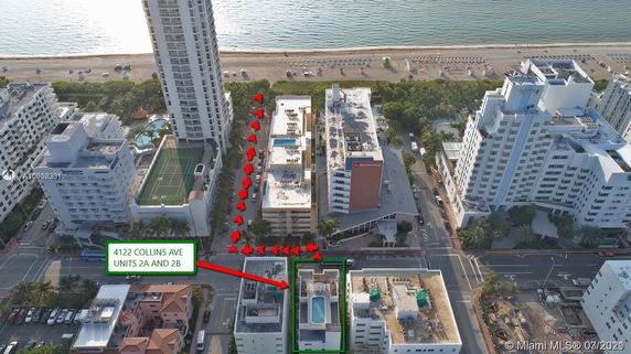 Aerial view of several multi-story buildings near a beach.
