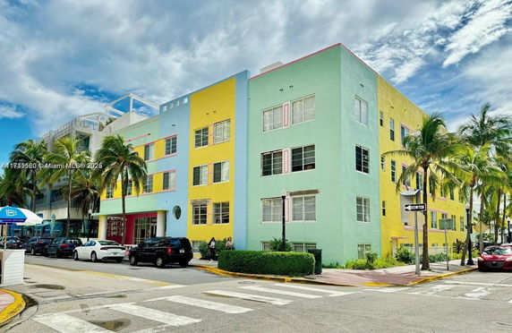 Front view of a colorful, multi-story building with bright yellow and green walls.