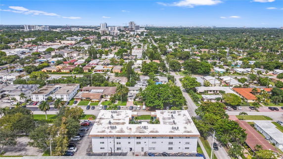 Aerial view of a neighborhood with multiple buildings and greenery.