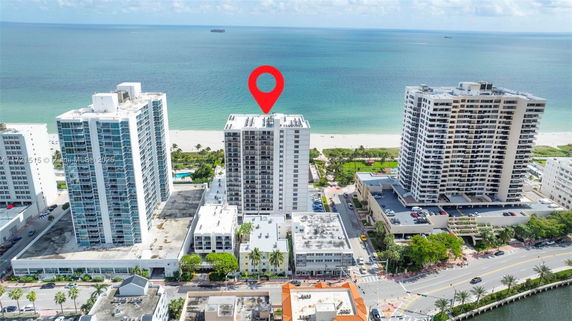 Aerial view of beachfront high-rise buildings with a placeholder icon above one building.