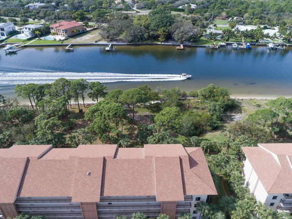 Aerial view of multiple building rooftops near a waterway.
