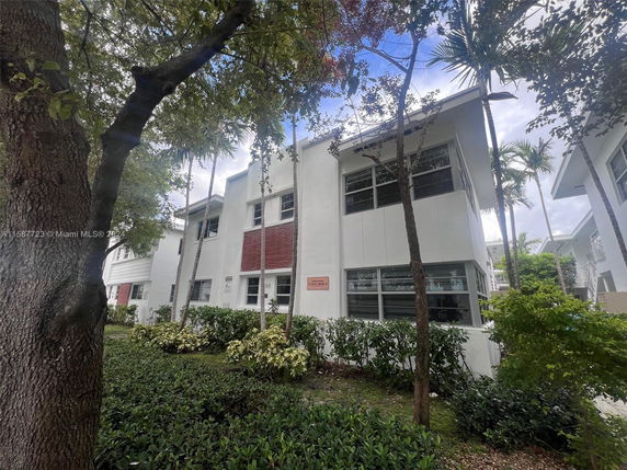 Front view of a two-story building with multiple windows and white exterior.