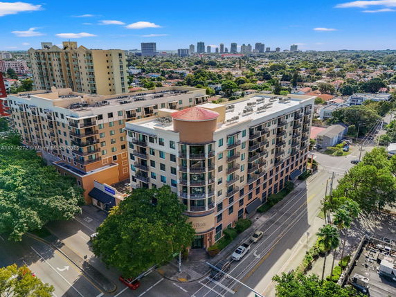 Front view of a large multi-story apartment building with balconies.