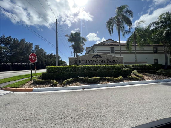 Front view of a building with a sign reading 'HOLLYWOOD PARC.'