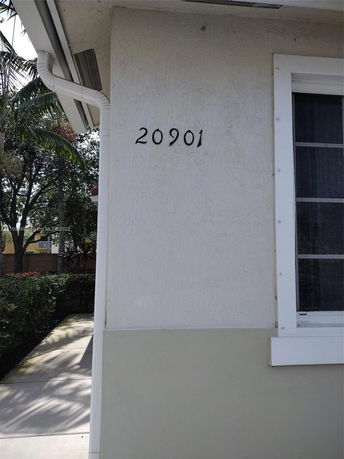 Partial view of a building with the number 20901 on the wall.