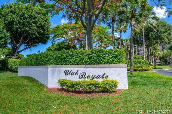 Sign with 'Club Royale' on a landscaped area.