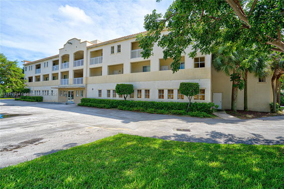 Front view of a multi-story residential building with balconies.