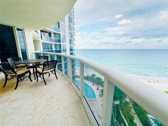 Balcony view overlooking the ocean and beach.