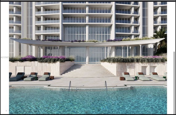 Front view of a building with a swimming pool and lounge area.