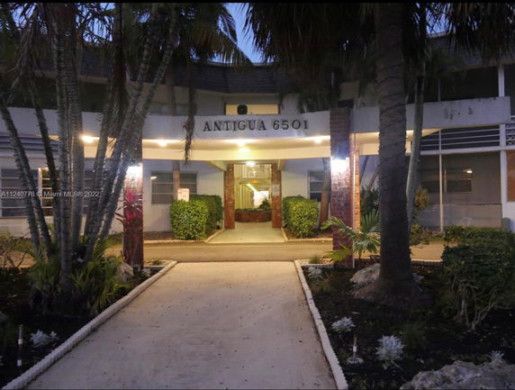 Front view of a multi-story building with illuminated entrance.