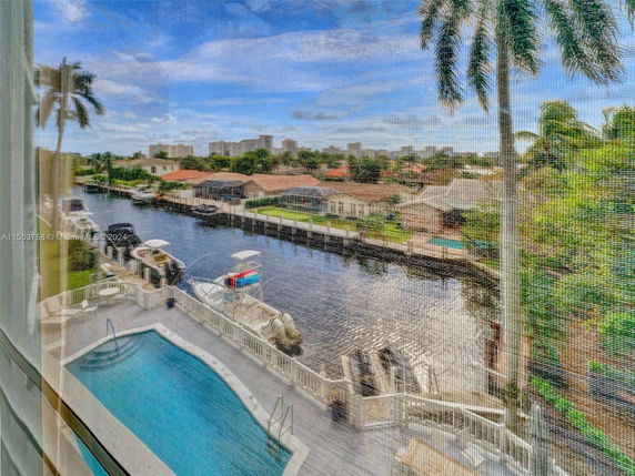View of waterfront properties and a pool from a building.