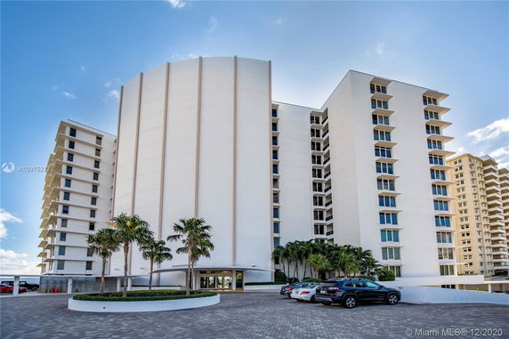 Front view of a multi-story residential building with a modern design and large windows.