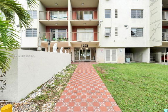 Front view of a multi-story residential building with balconies.