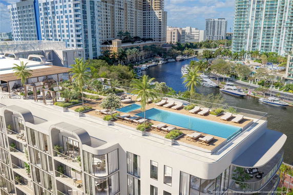 Rooftop with a swimming pool and lounge area on a multi-story building.