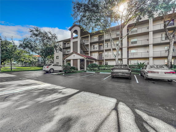 Front view of a multi-story apartment building with balconies.