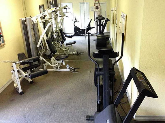 Indoor gym with exercise equipment and fitness machines.