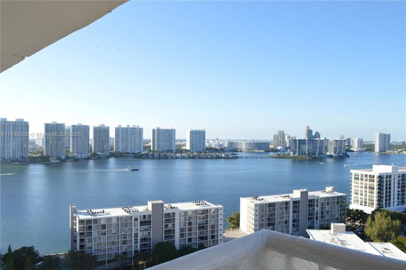 Panoramic view of high-rise buildings and a body of water.