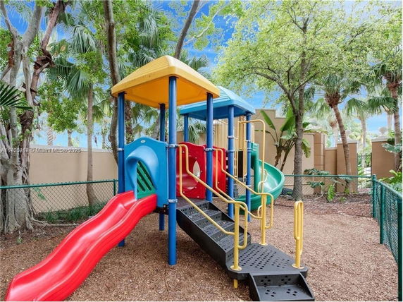 Outdoor playground with colorful slides and climbing structure.