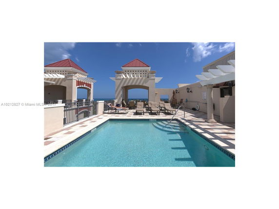 Rooftop area featuring a swimming pool with seating areas around it.