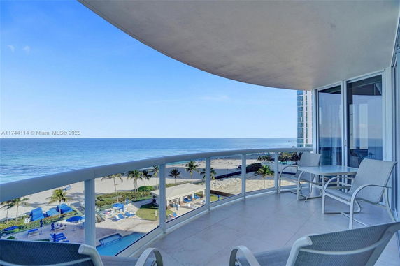 Balcony view overlooking the ocean and beach area.