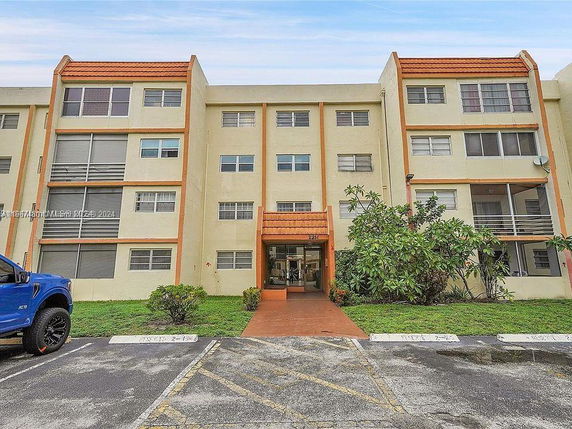 Front view of a multi-story residential building with balconies.