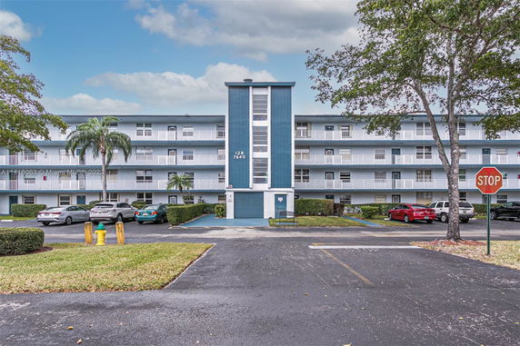 Front view of a multi-story apartment building with a central entrance.