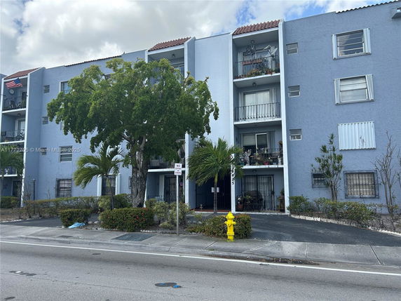 Front view of a multi-story residential building with balconies.