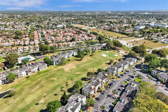 Aerial view of a suburban area with residential buildings and green spaces.