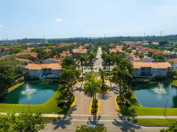 Elevated view of a residential area with buildings and landscaped ponds.