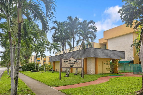 Front view of a condominium building with a sign reading 'Las Estrellas'.