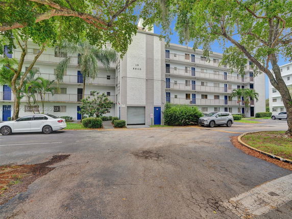 Front view of a multi-story apartment building with balconies.