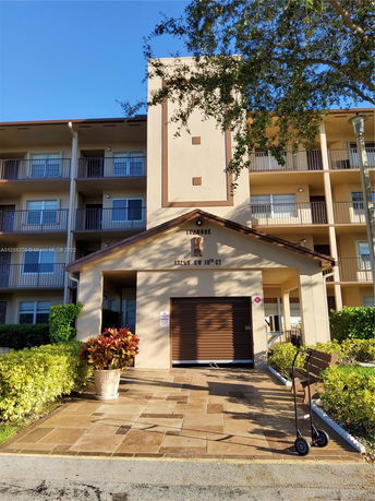 Front view of a multi-story residential building with balconies.