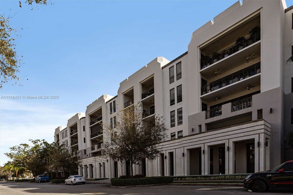 Front view of a modern multi-story building with balconies.