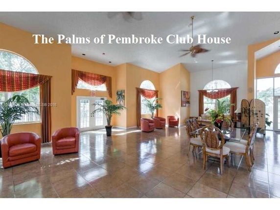 Interior of a club house with seating arrangements and large windows.