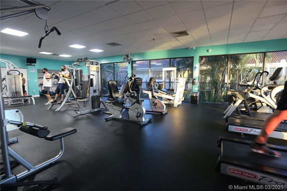 Interior view of a fitness gym with various exercise machines and equipment.