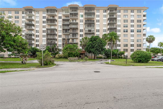 Front view of a multi-story residential building with balconies.