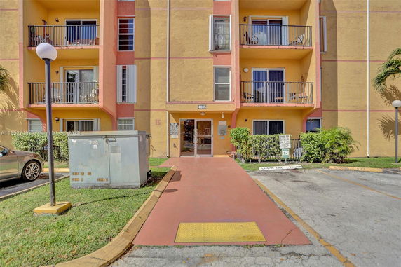 Front view of a multi-story building with balconies.