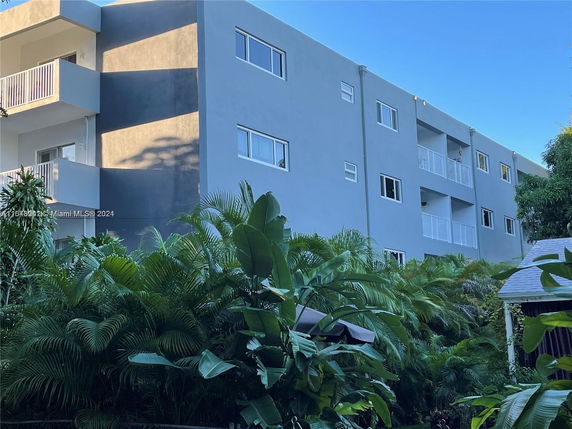 Front view of a multi-story building with balconies.