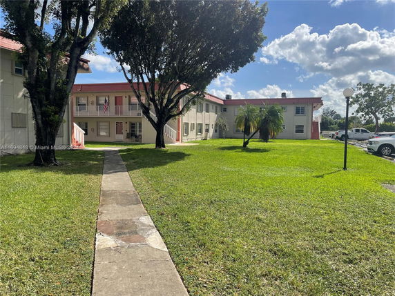Front view of a two-story residential building with a central walkway.