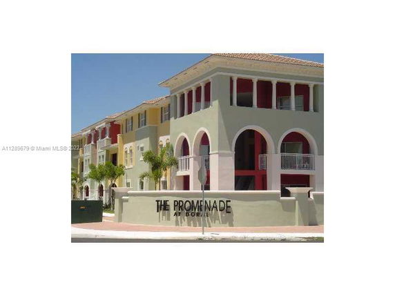 Front view of a multi-story building with multiple arches and balconies at The Promenade at Doral.