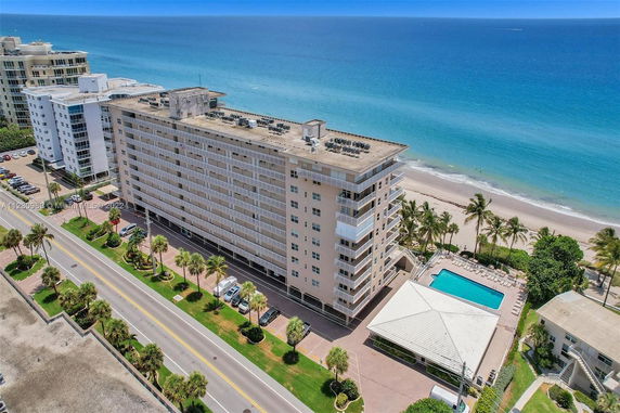 View of a multi-story beachfront building near the ocean.